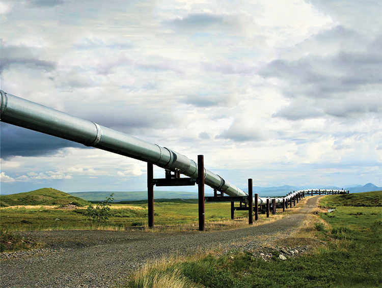 heavy crude pipeline stretching from left to right on a cloudy day