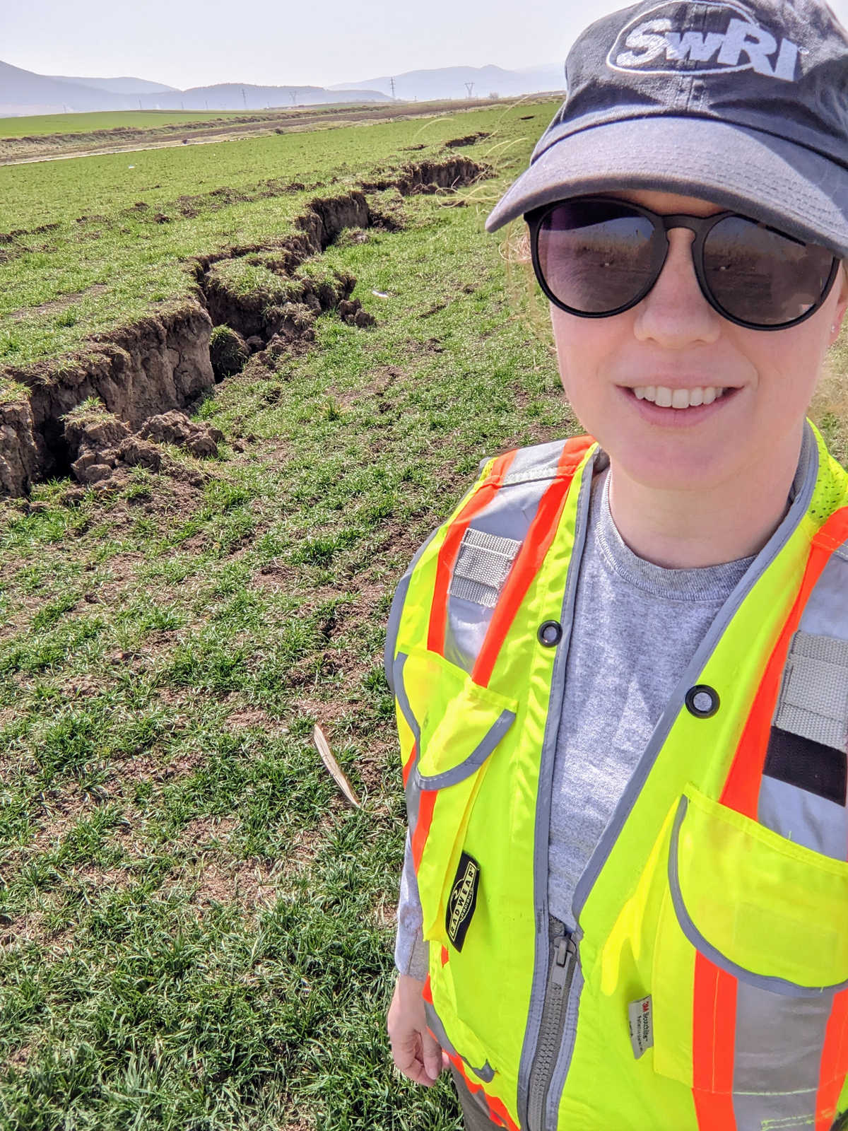 Dr. Kristin Ulmer standing near surface rupture caused by the February 2023 earthquakes in Turkey