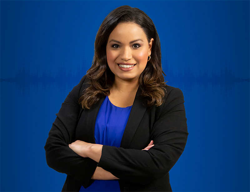 Lisa Peña against a solid blue background