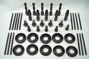 assorted cogs and parts arranged on a white surface to show atmospheric plasma deposition