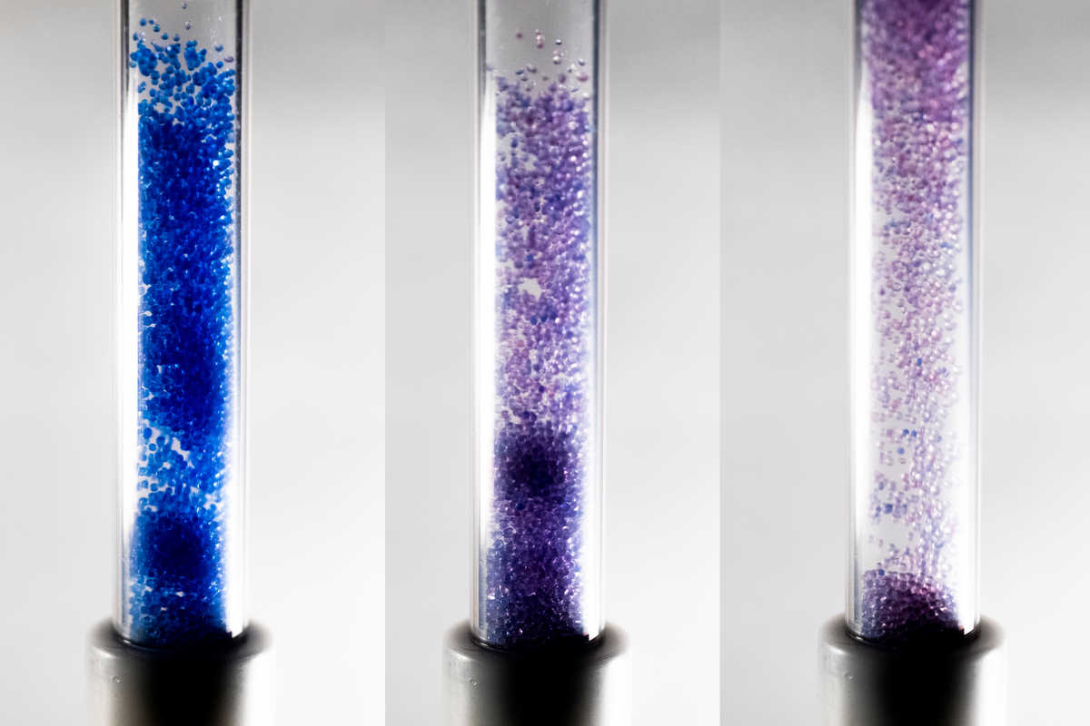Three glass tubes with colored silica gel beads during atmospheric water harvesting