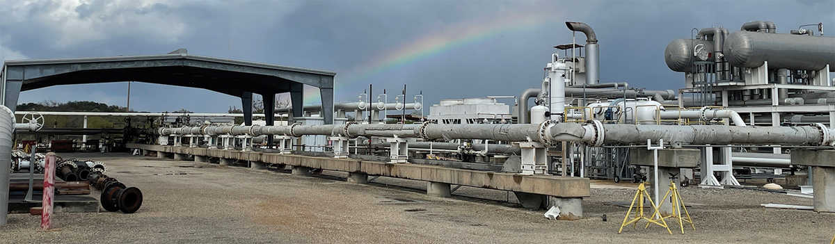 metering research facility with cloudy sky and rainbow