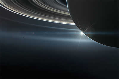 Close-up of Saturn and its rings with the Sun in the background