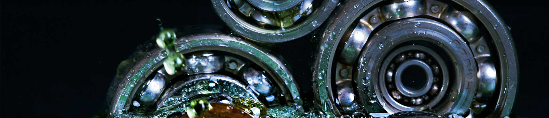 silver gears with green liquid falling around it