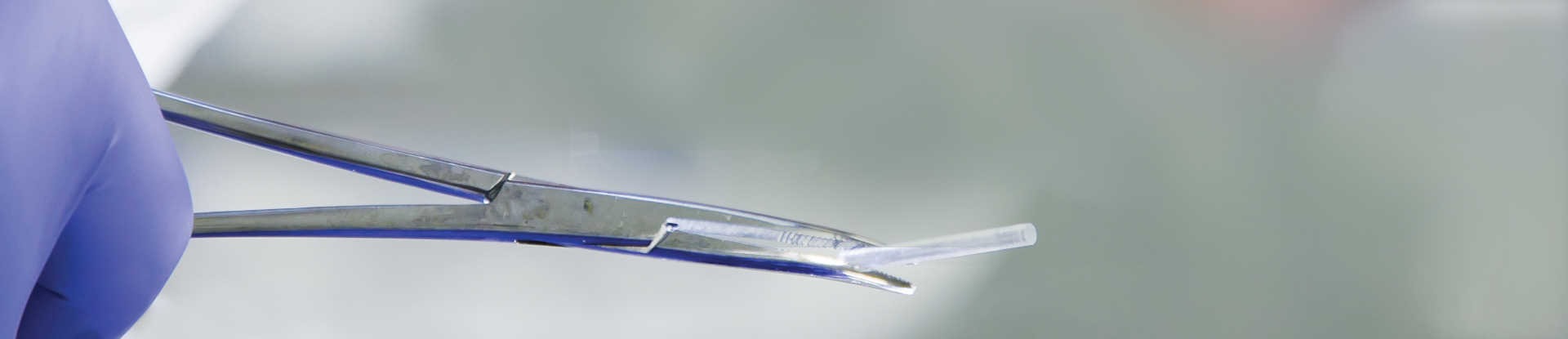 A subdermal implant held by a medical clamp