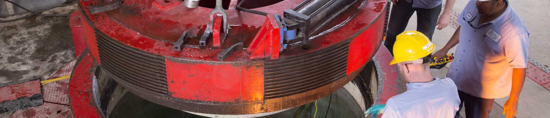 SwRI technicians lowering a specialized cover over a chamber in the ocean simulation lab
