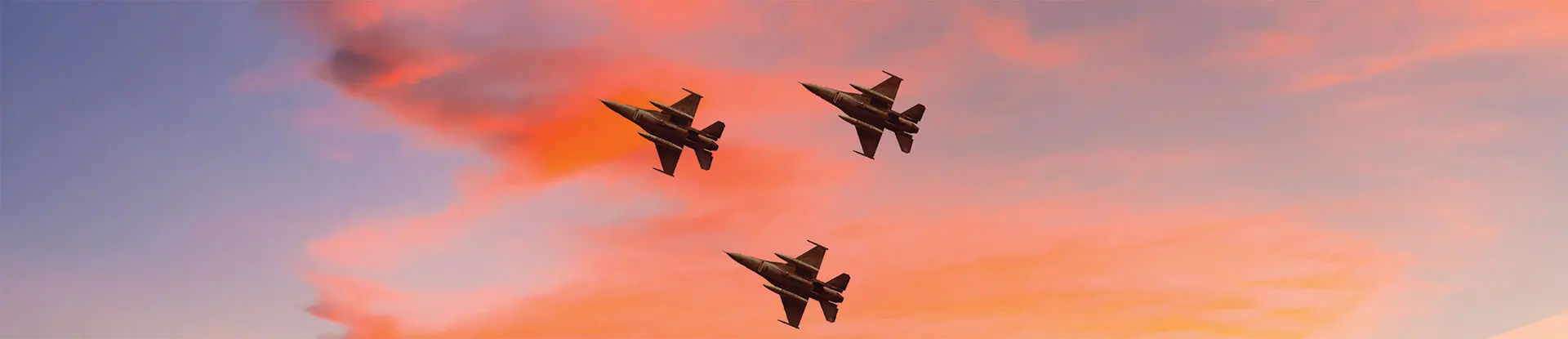 Silhouette of three airplanes with colorful sunset sky background