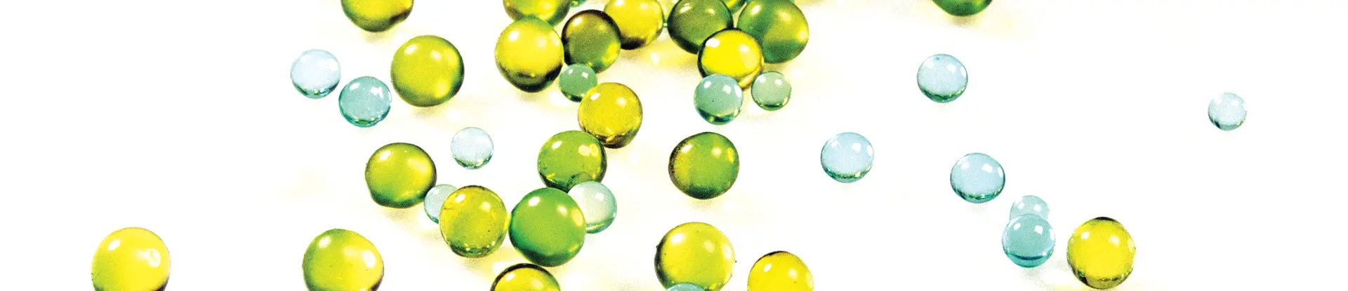 Green, yellow, and blue round orbs spilling across white surface