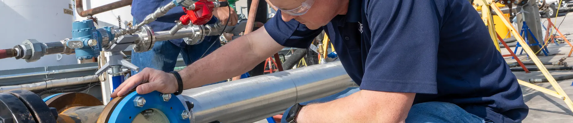 Two men working on the High-Viscosity Flow Loop 