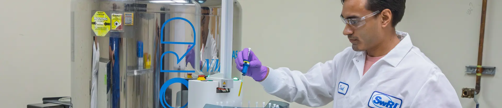A chemist operates the nuclear magnetic resonance machine in the NMR Laboratory at SwRI