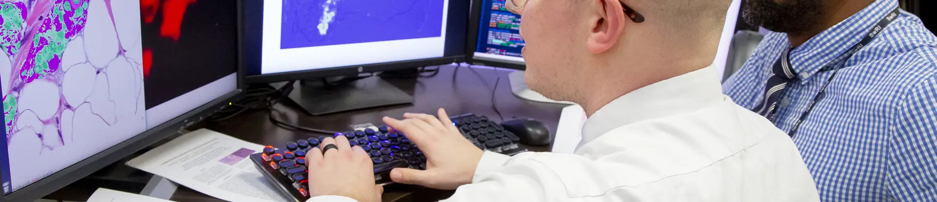 SwRI engineers David Chambers and Donald Poole analyze breast cancer tumor cells