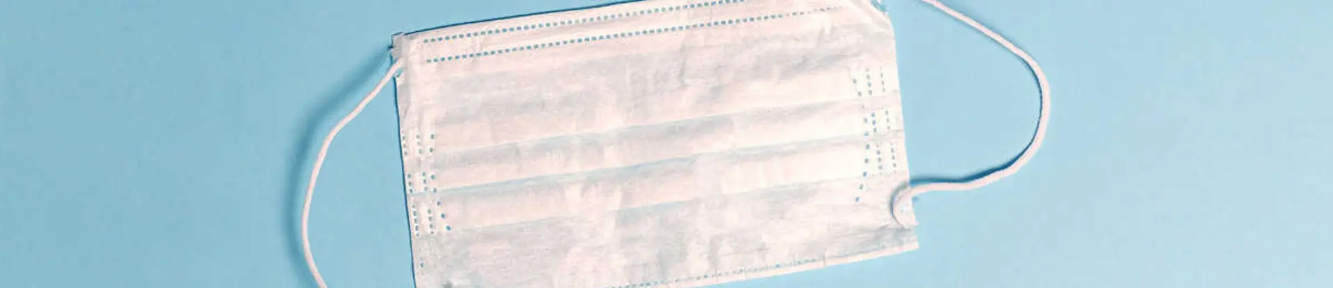 White face mask on light blue background