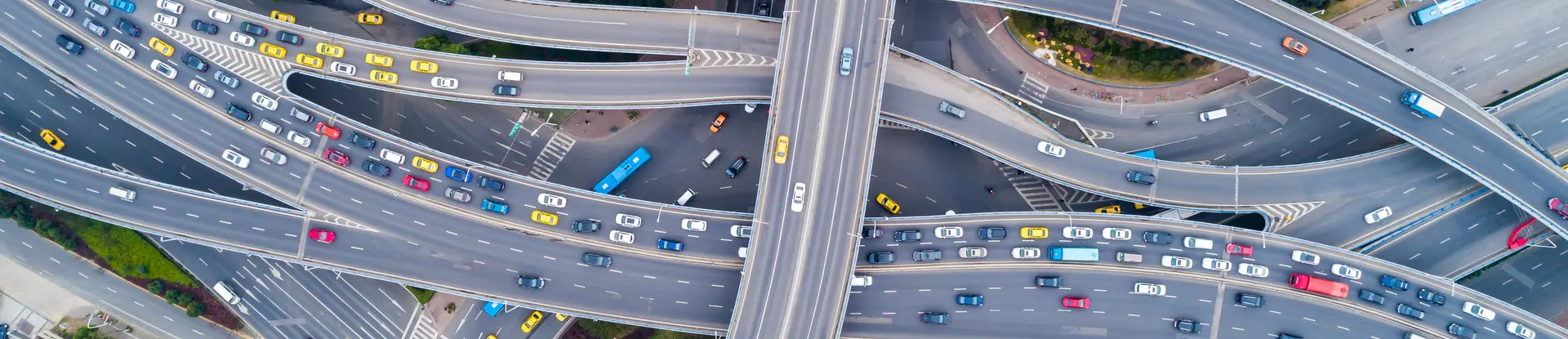 Aerial view of a freeway interchange with many cars on the road