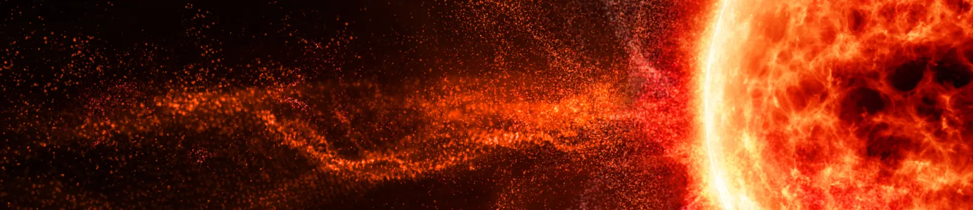 Glowing orange sun with solar flare particles against black space