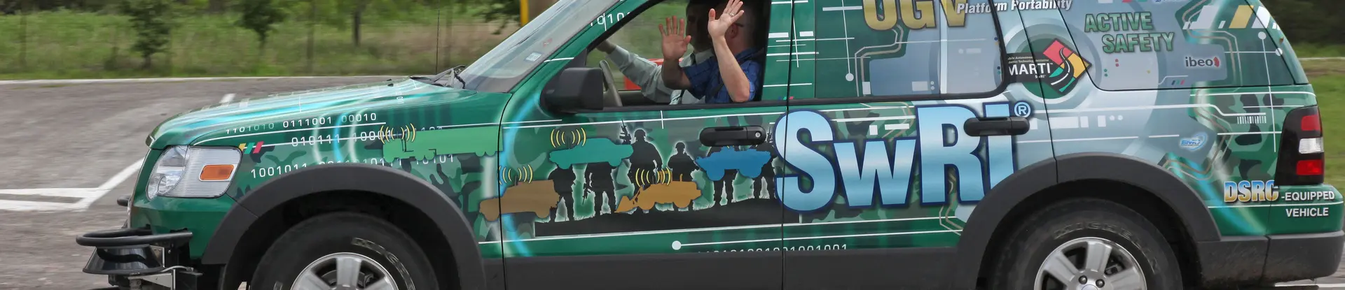 Passengers ride along in an SwRI automated vehicle as it traverses a test track