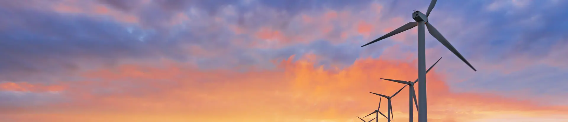 Sunset with windmills along side a winding road