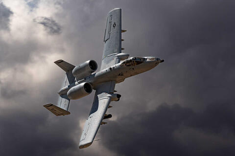 A-10 Thunderbolt flying in a dark sky