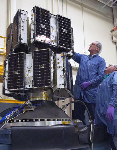 CYGNSS) microsatellite constellation is pictured Two men performing vibration stand testing at SwRI on the CYGNSS microsatellite constellation