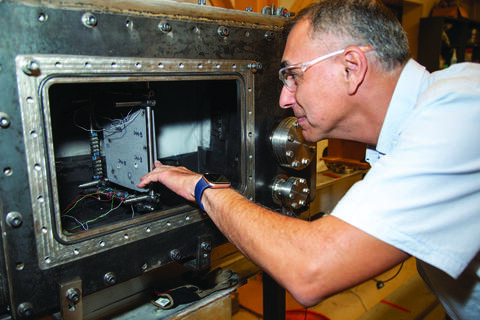 Engineer working on the micrometeoroid and orbital debris (MMOD) detection and characterization system 