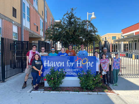 group of people standing behind Haven for Hope sign