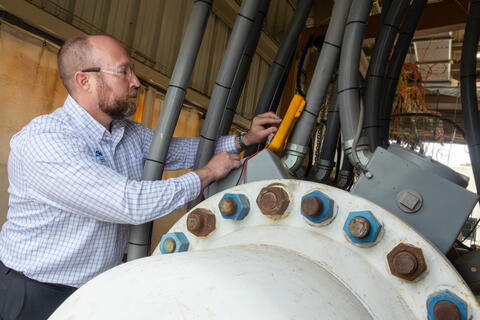Engineer working in the High Energy Annex Test (HEAT) facility at SwRI