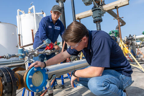 Two men working on the High-Viscosity Flow Loop 
