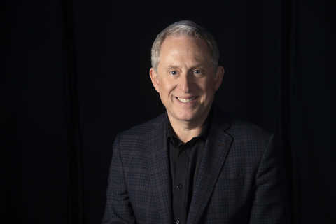Alan Stern in front of a black background