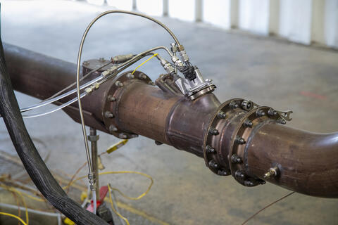 Close up of meter on a metal pipe measuring nitrous oxide (NOx) and carbon dioxide emissions for Catalyzed Diesel Exhaust Fluid (Cat-DEF™) 