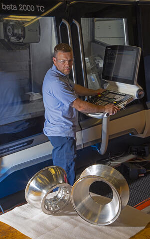 CoDICE metallic instrument sitting on a table with a technician in the background