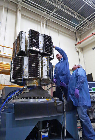 The eight microsatellites that make up the CYGNSS constellation are shown on the deployment module being readied for vibration tests. Vibration testing simulates the environmental conditions the systems will undergo during captive carry on the Orbital-ATK