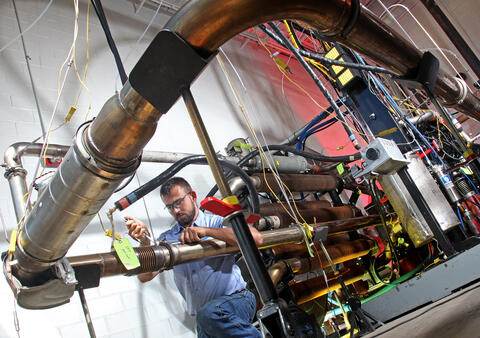 Large emissions testing facility with a researcher inspecting