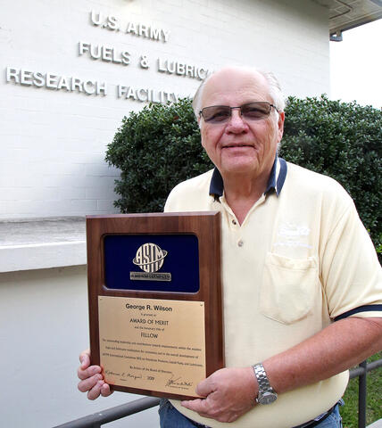 George Wilson, standing and holding the ASTM Award of Merit