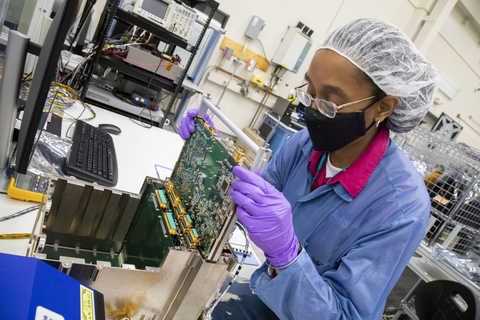 Engineer installing an electronics box for SwRI’s novel MASPEX instrument