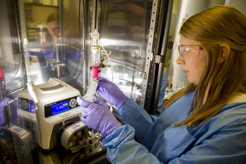 Perfusion controller system in a lab with a scientist inspecting materials 