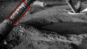 Black and white photo of lander on Mars with droplets visible on a lander leg
