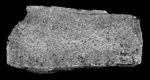 Spherule sample showing small glassy particle layers