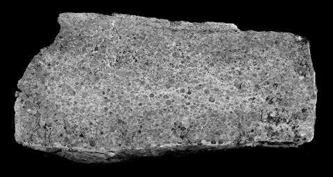 Spherule sample showing small glassy particle layers