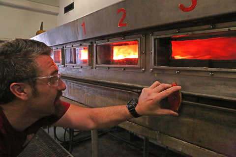 A Fire Technology technician measures the flame spread index during a fire test using standard ASTM E84 in the Steiner Tunnel. 
