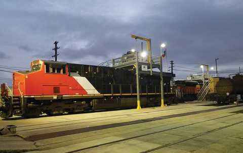 Black and red parked train at dusk