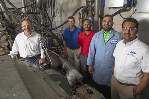 Team members standing around the low-NOx test cell