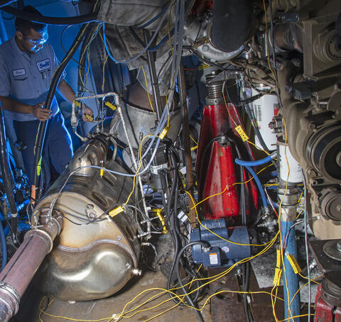 Test cell with wires and a technician standing nearby
