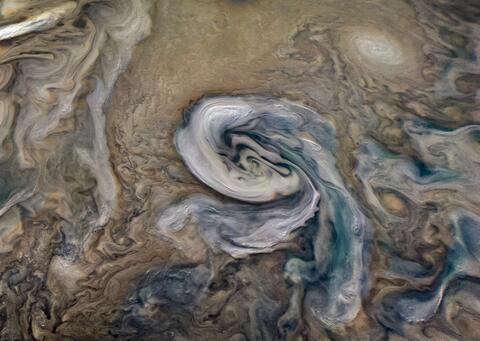 White clouds of ammonia, rotating anticlockwise above Jupiter