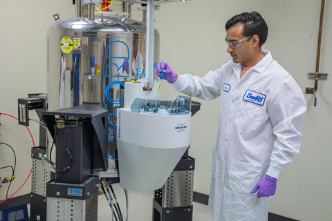 A chemist operates the nuclear magnetic resonance machine in the NMR Laboratory at SwRI