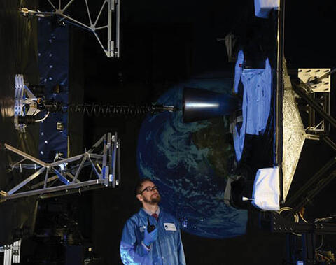 Satellite docking system and a technician in a laboratory