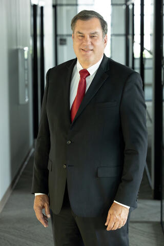 Portrait of Dr. Steven Dellenback, vice president of Southwest Research Institute’s Intelligent Systems Division, in a bright sunny office room