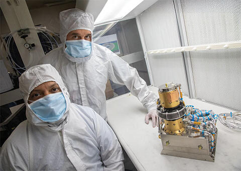SwRI’s Dr. Robert Ebert (right) and Prachet Mokashi next to the SWiPS instrument