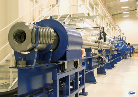 SwRI's 72-feet-long two-stage light gas gun in a test lab