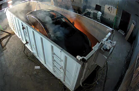 electric vehicle on fire in containment system