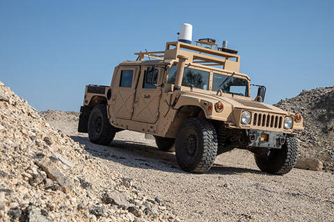 A truck with Vision for Off-Road Autonomy (VORA) tool, a passive camera system to perceive objects.