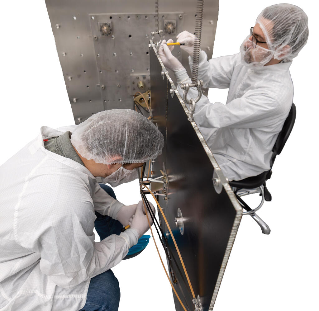 Two SwRI staff in white jumpsuits working on PaSTA
